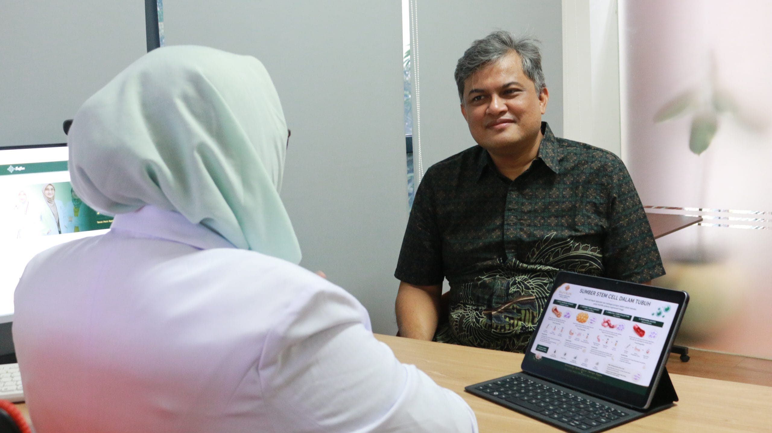 Compassionate doctor consulting with senior patient